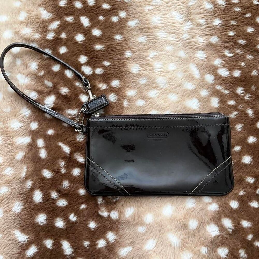 Coach black patent leather wristlet with silver hardware and pink inside